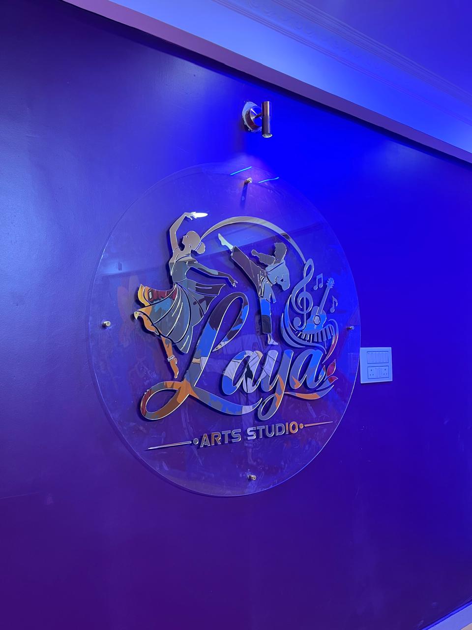 Official 3D acrylic illuminated Laya Arts Studio emblem on feature wall