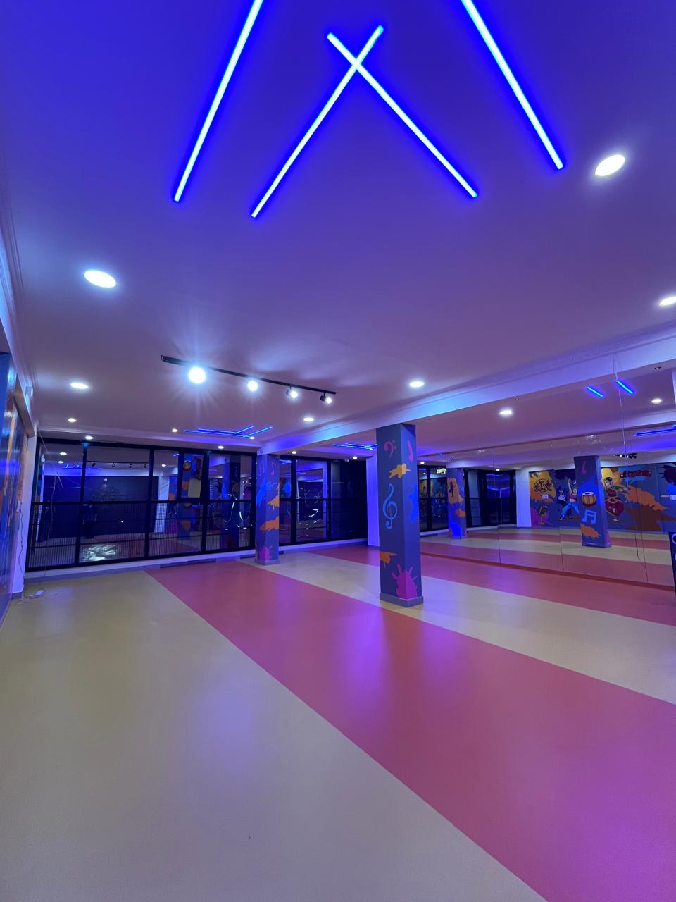 Professional dance hall with ceiling track lighting, audio acoustics and mirrors
