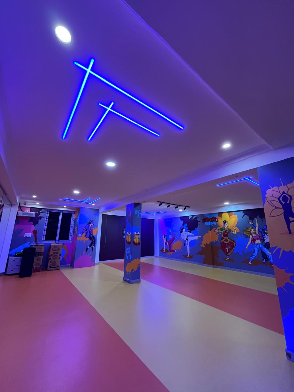 Artistic dance and martial arts murals with neon chevron ceiling lighting